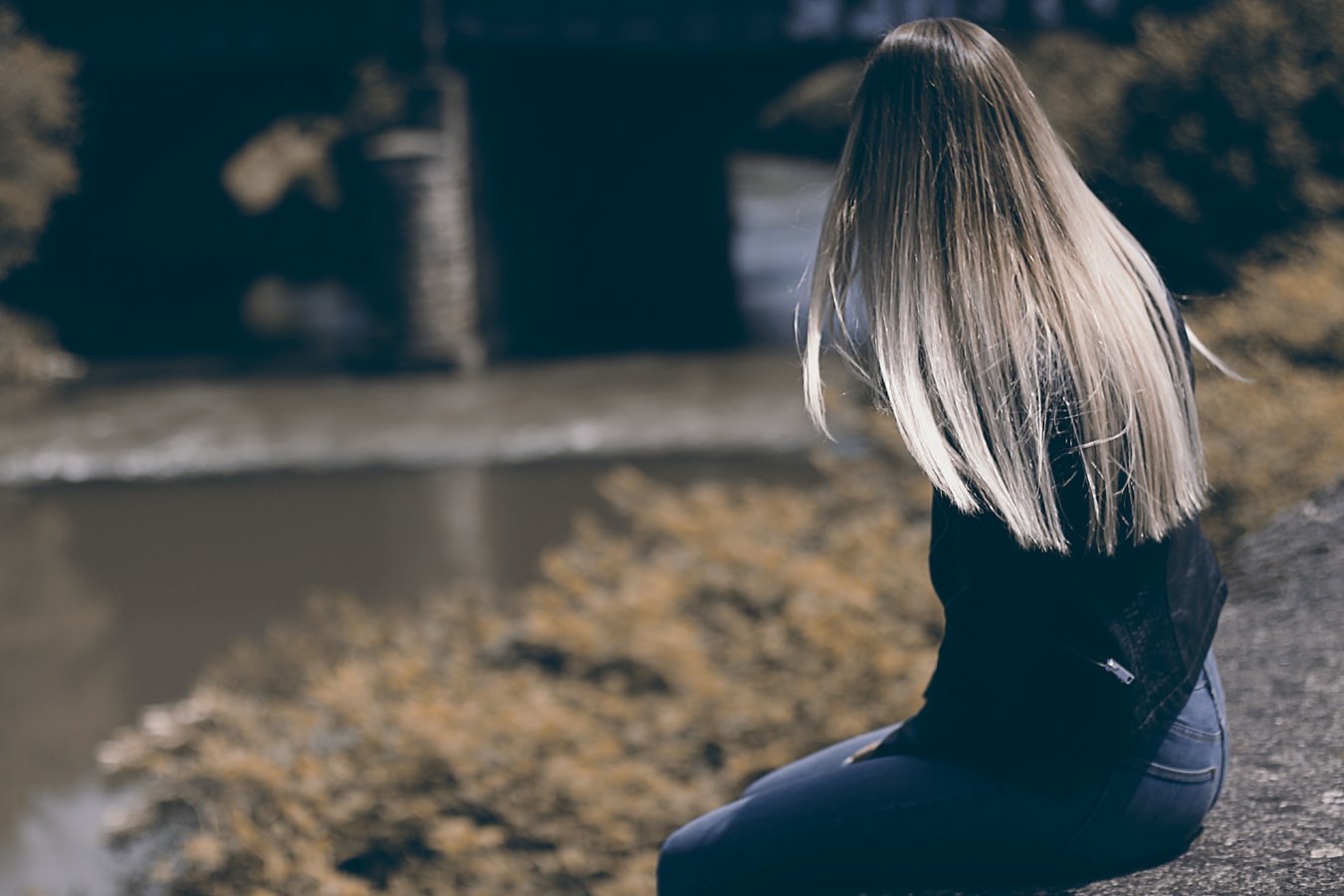 A woman sitting and thinking about Smart Recovery