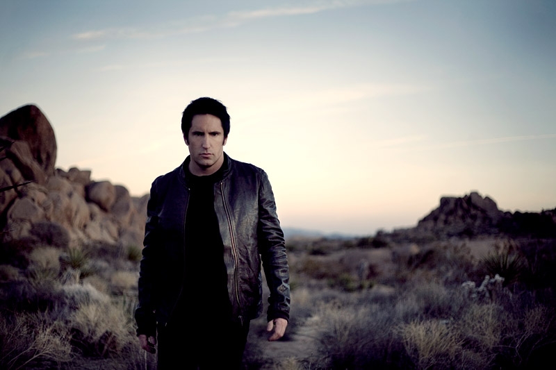 A photo of Trent Reznor walking in the desert