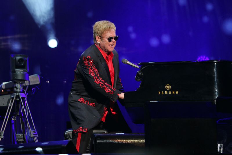 Elton John performing on the piano