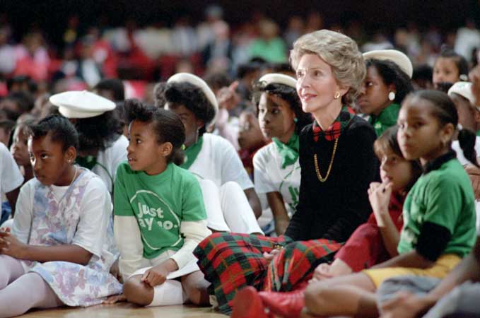 Nancy Reagan sitting with children at a Just Say No rally