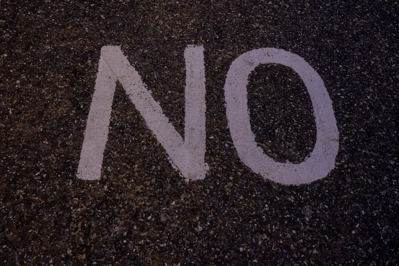 The phrase No painted on the sidewalk