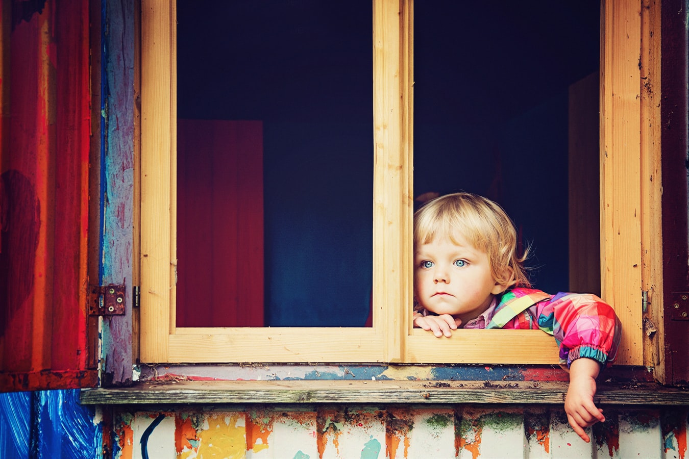 A young child looking out a window