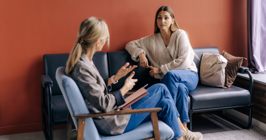 A woman talks to a therapist about her anxiety fueled addiction. Find Therapy When Anxiety Fuels Addiction