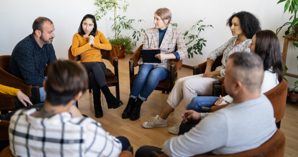 Individuals in an outpatient treatment program meeting for a therapy session