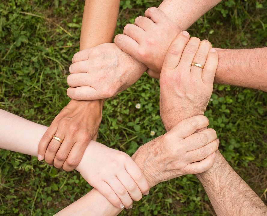 Individuals holding hands. Attending family therapy is one of the best thing you can do for addiction recovery.