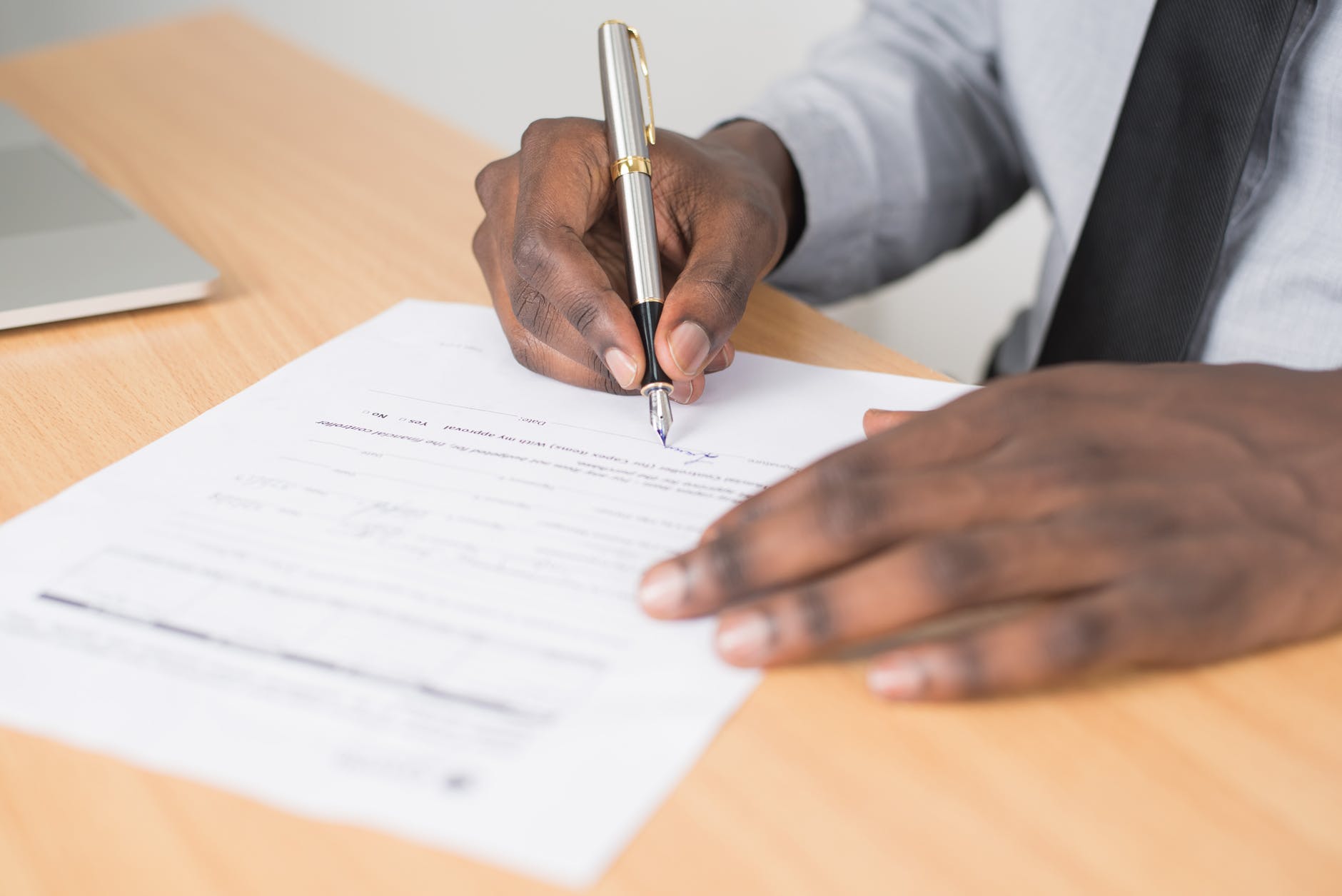 A man signing a legal document. Confidentiality is important when entering Kentucky recovery centers