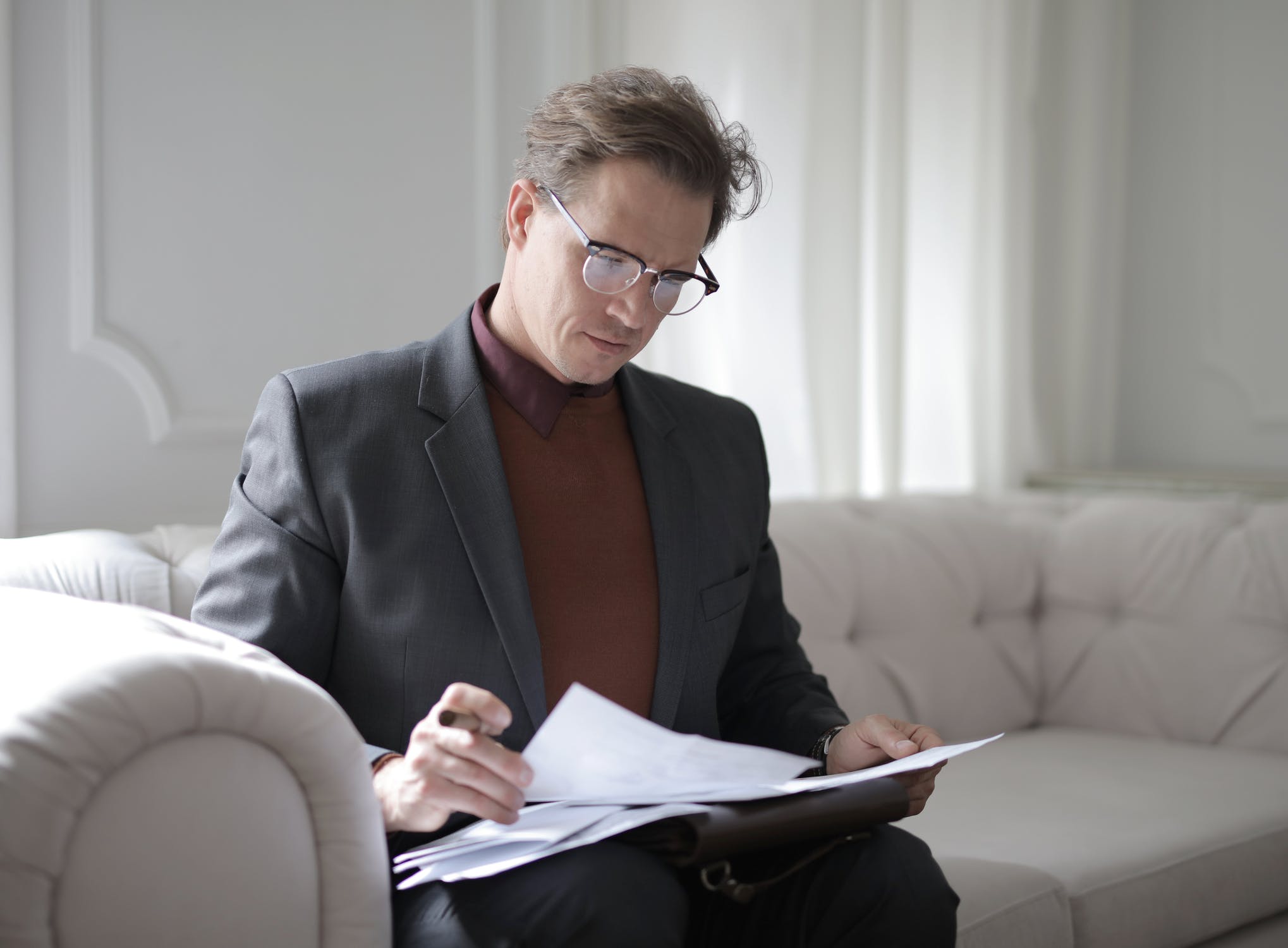 A man reading over paperwork related to an opioid class action lawsuit
