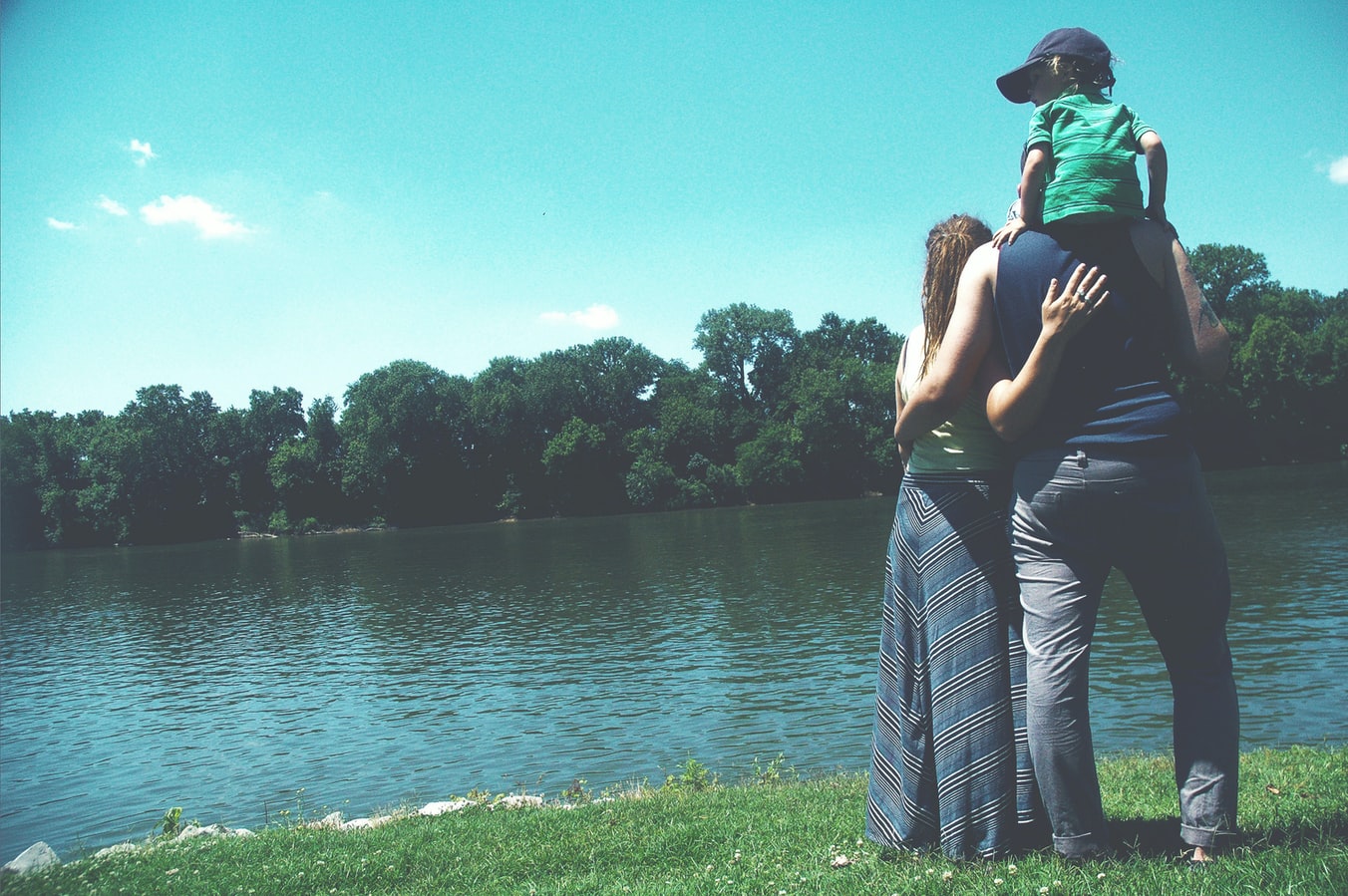 A family standing near a lake that has been engaging in family therapy for addiction treatment