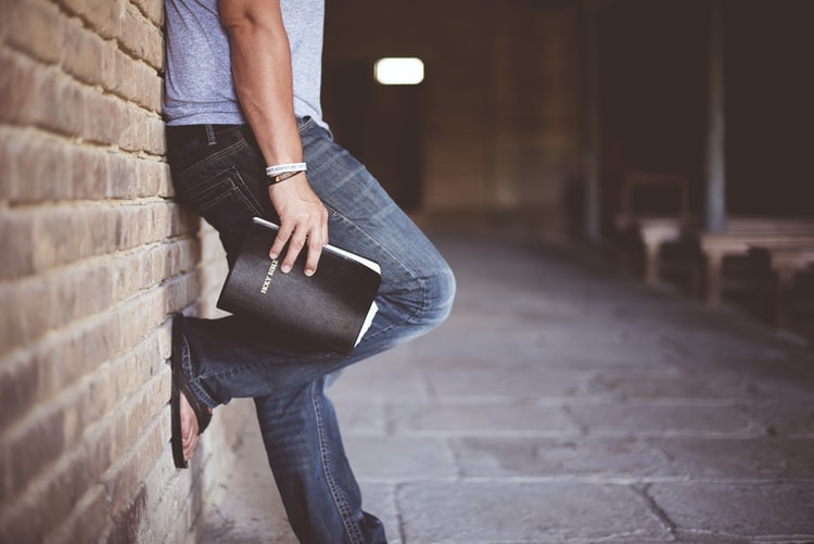 A man holding a bible before going to a Celebrate Recovery meeting