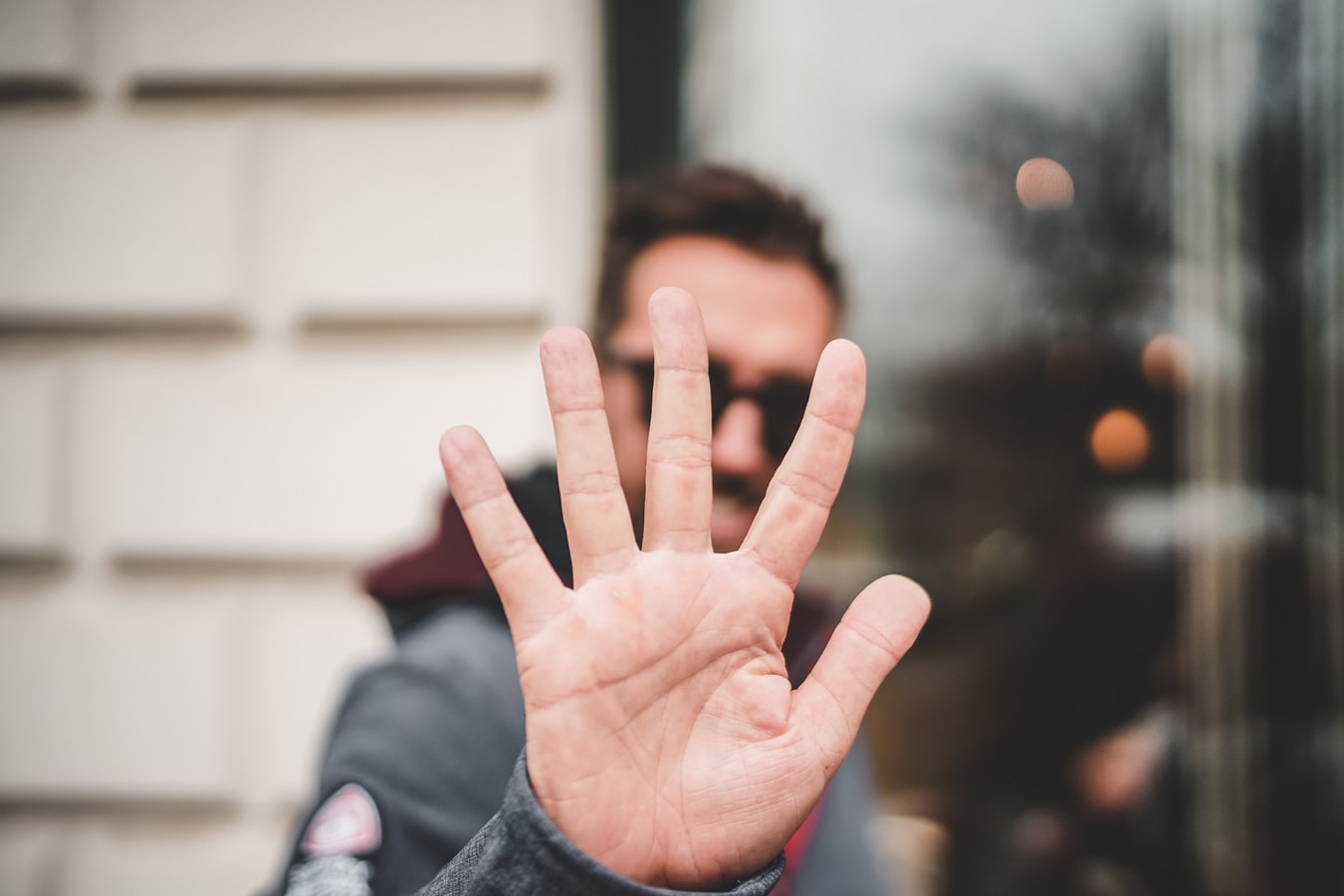A man holding out his hand to show that there are five steps to rebuild your life after recovery