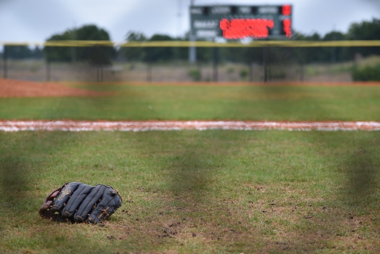 A softball mitt on a softball field