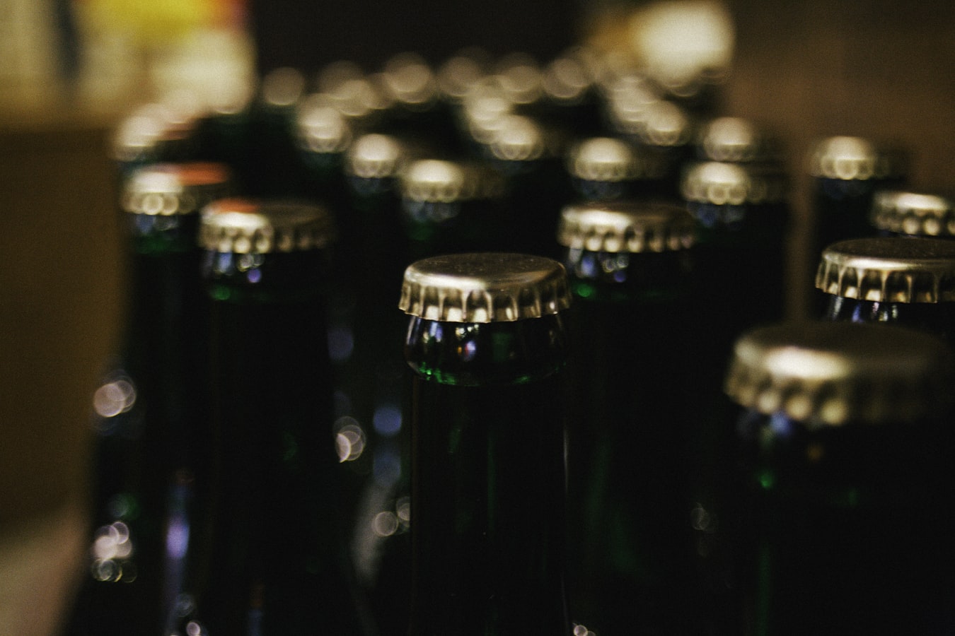 Closed beer bottles on a table. There are many dangers to mixing alcohol and morphine