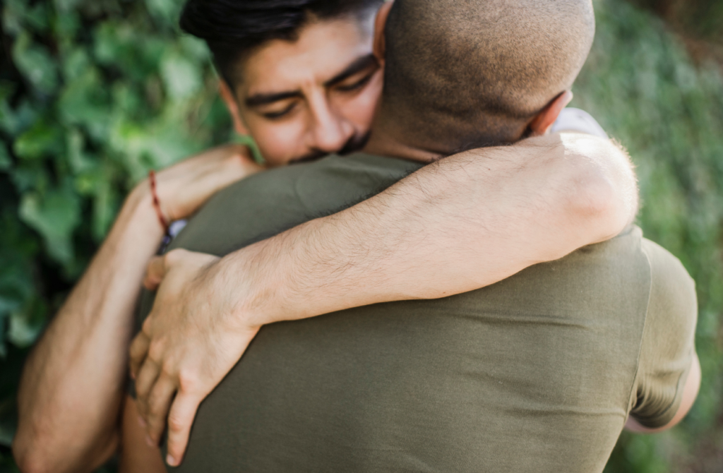 Two men share a hug. 