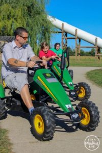 Wasson riding John Deer ATVs with kids