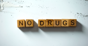 Wooden blocks with letters on them, which spell "no drugs" to communicate what harm reduction's primary focus is in Kentucky.