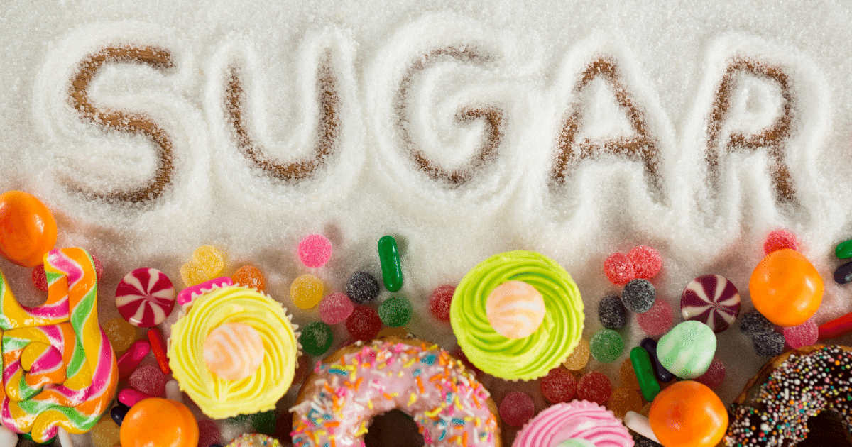 The word sugar written in a pile of sugar