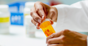 A pharmacist's hands are seen bottling pills for a prescription to be picked up at the pharmacy. The Kentucky Legislature won't beat the opioid epidemic without widespread assistance according to Sen. Ralph Alvarado and others.