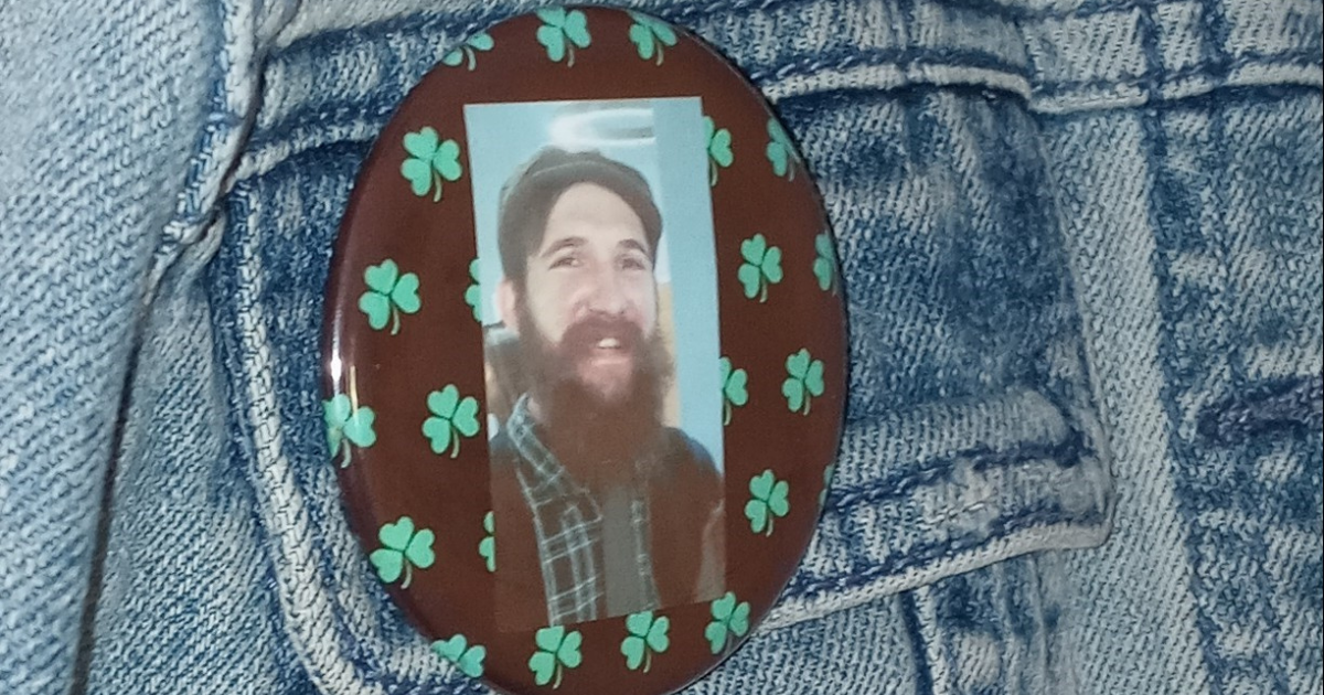 A button pin with Patrick Kilbane's face on it