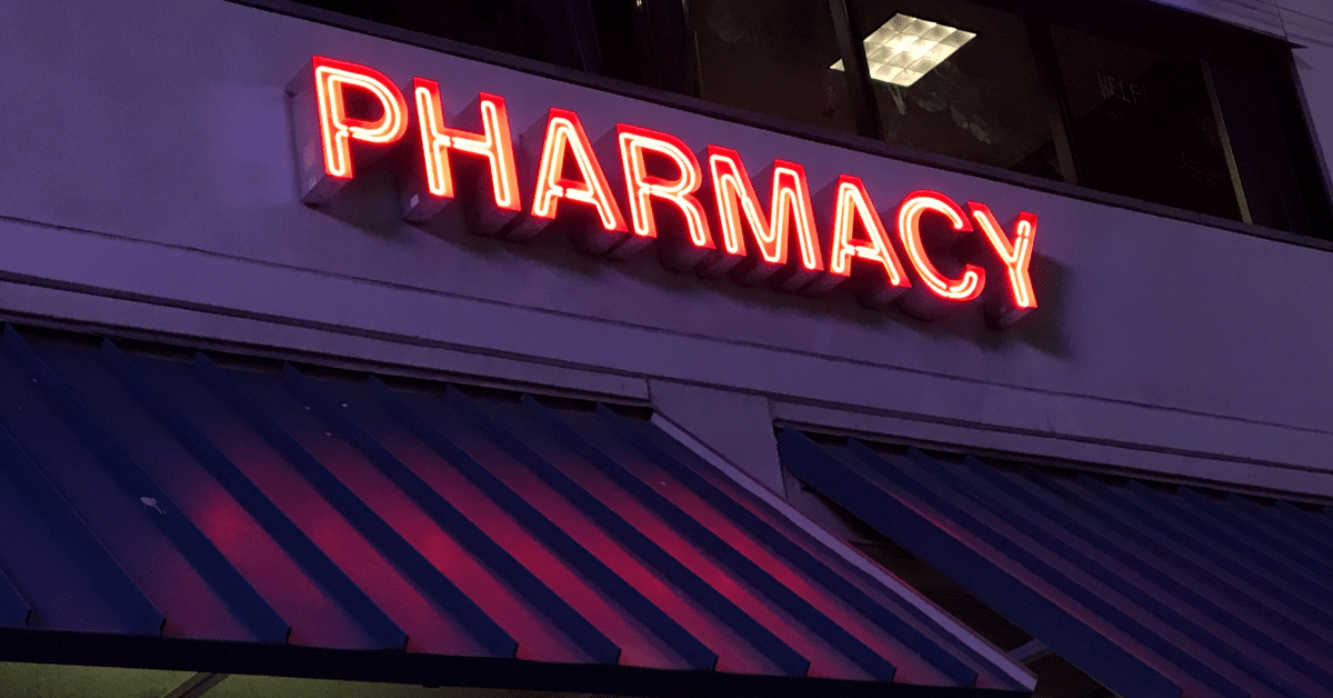 A neon sign that reads, "Pharmacy," evokes mixed responses amid the opioid crisis.