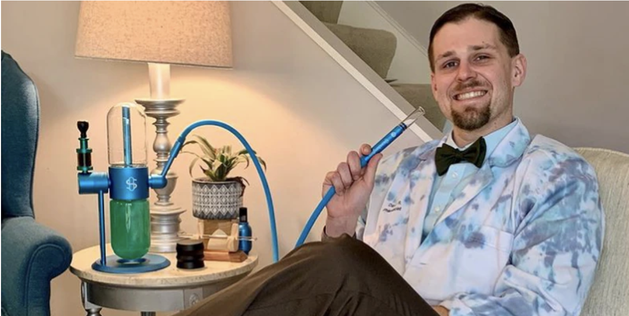 David Robinson, founder of Absurd Cannabis Experience, demonstrates use of his new studenglass gravity hookah product for recreational marijuana use.