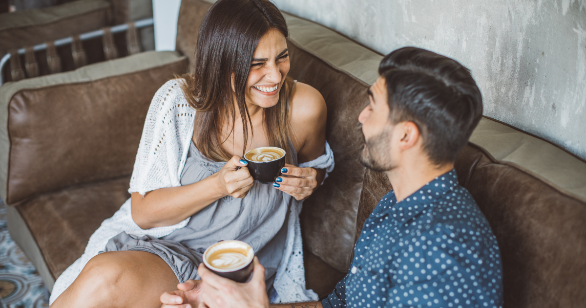 a man and woman in early addiction grab coffee and talk on their first date