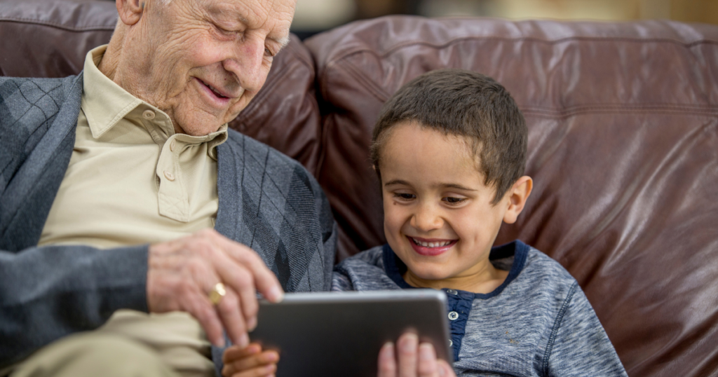 a grandfather uses a video on a tablet to help explain addiction to a child