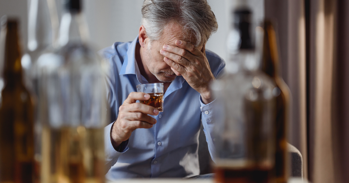 a man drinks alcohol after making quitting alcohol his new year's resolution