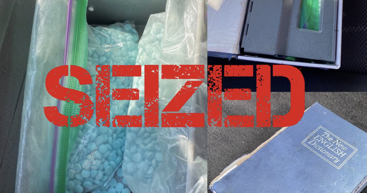 DEA image of seized fentanyl pills in the hollowed-out dictionary.