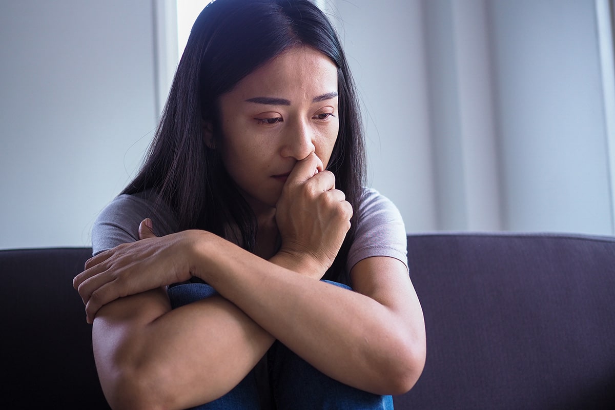 person on couch looking anxious while considering under the influence meaning