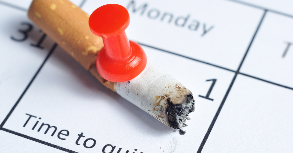 a cigarette is pinned to a calendar to remind a person to quit smoking for their personal health