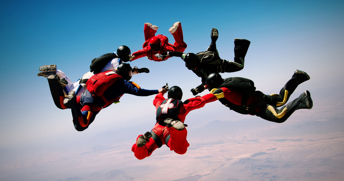 a group of men in recovery go skydiving during their bachelor trip