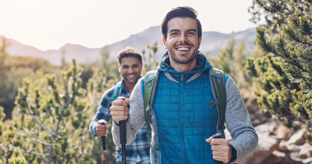 two men in addiction recovery hike during a bachelor trip