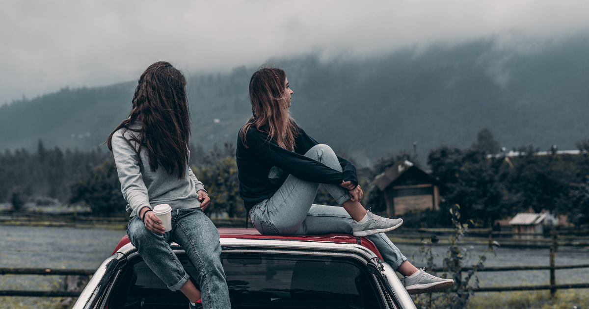 two women sitting on a car thinking about comorbid and cooccurring disorders