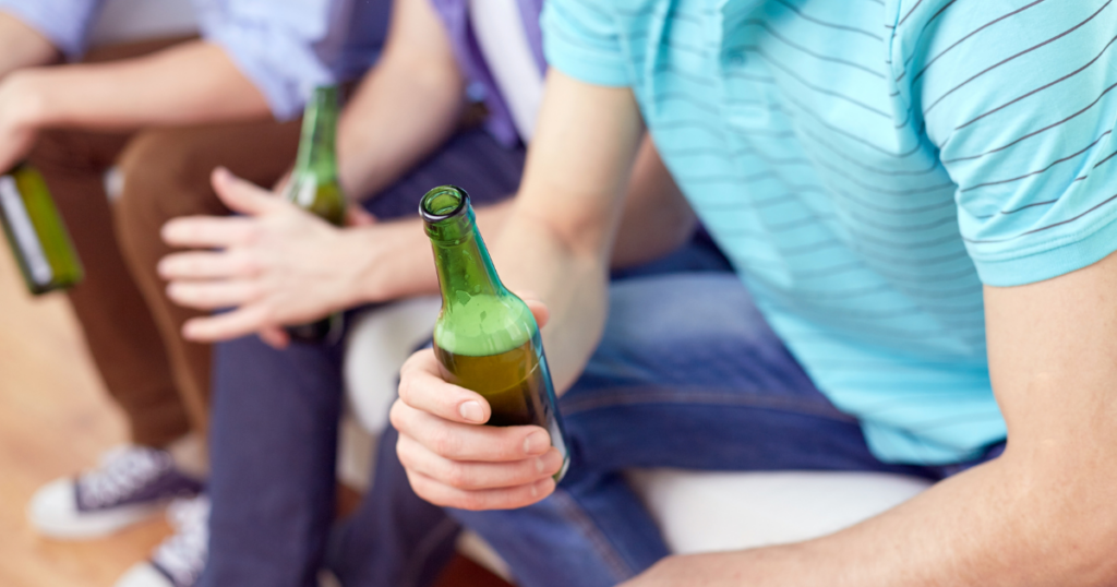 two young adults binge drink beer, which is common among teens and young adults between 12-25, according to the 2021 National Survey on Drug Use and Health (NSDUH)