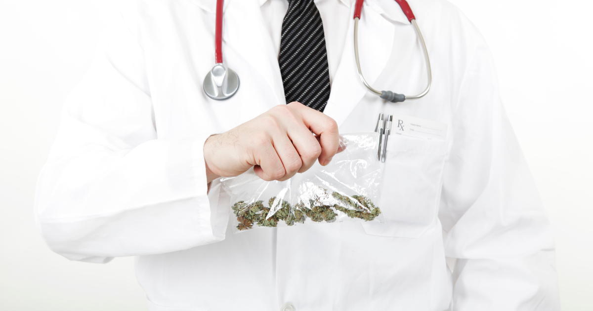 A medical doctor holds up a bad of marijuana during rehab