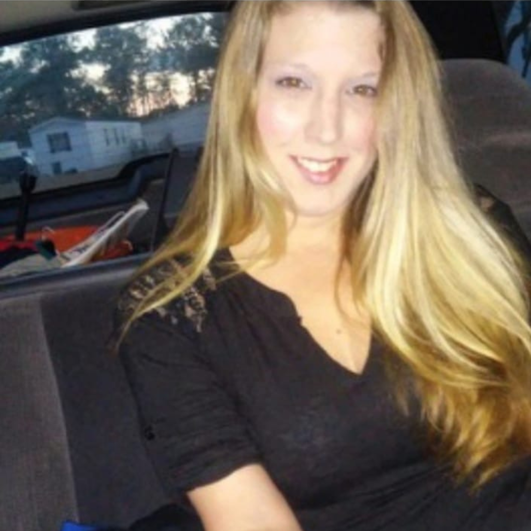 Melissa Phillips is pictured in the backseat of a car