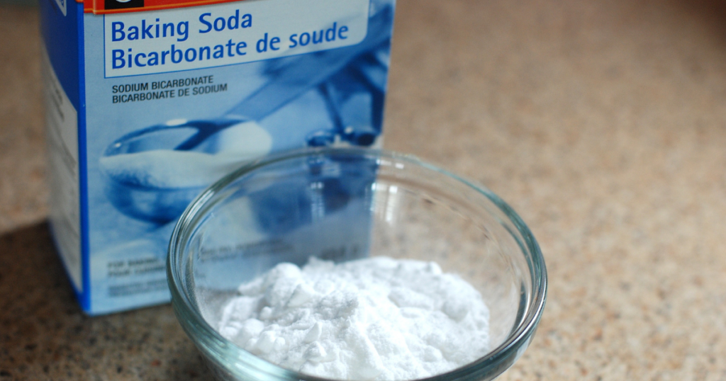a box and bowl of baking soda sit on a table. This compound also known as sodium carbonate is a common cutting agent used to stretch cocaine