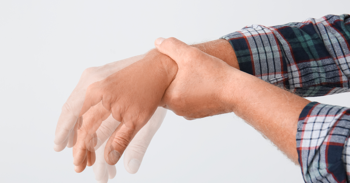 a man holds his shaking hands after going through alcohol withdrawal